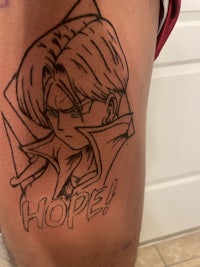 a tattoo of a dragon ball character on a person's thigh